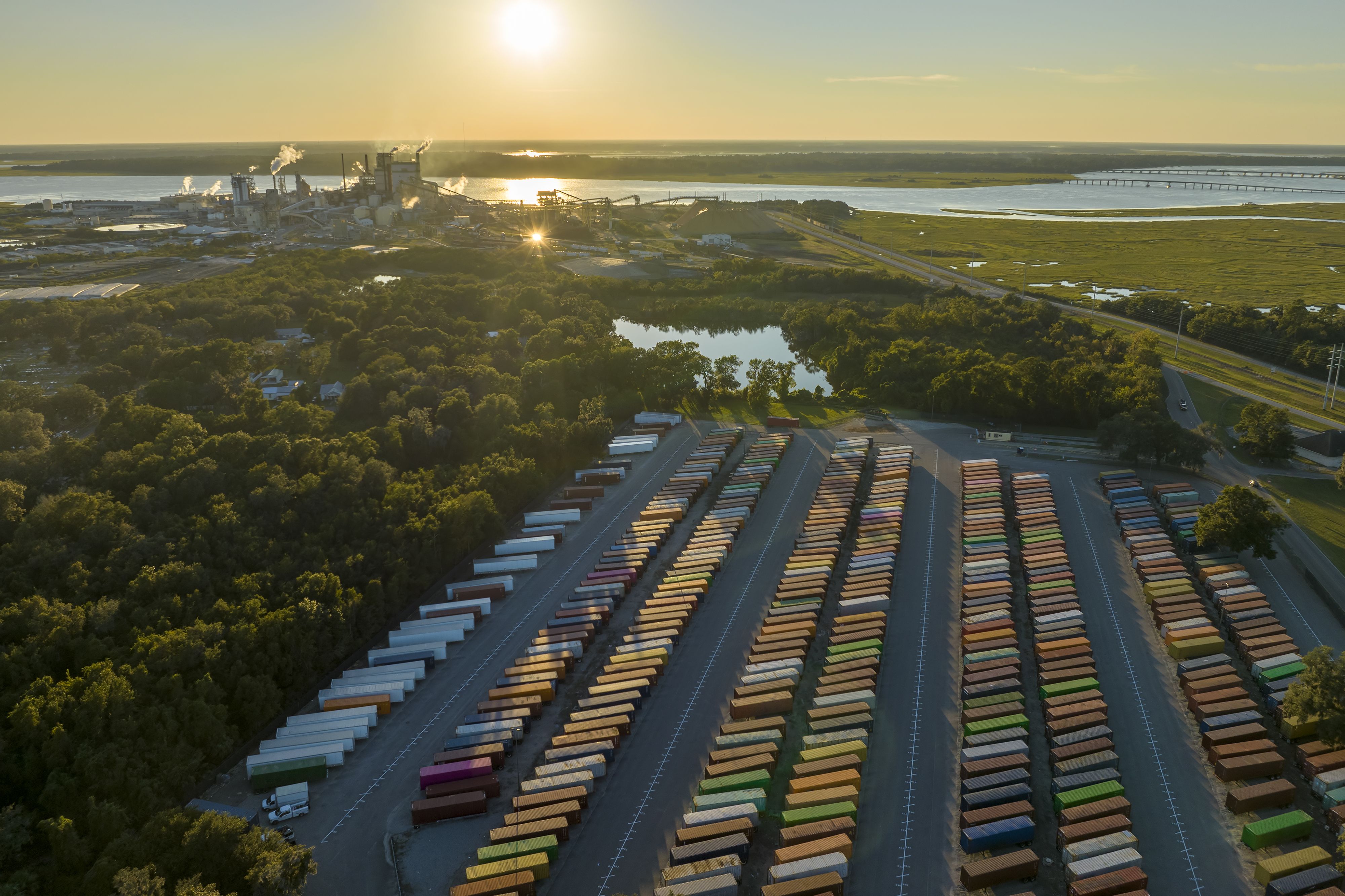 a truck is parked in front of a bunch of shipping containers